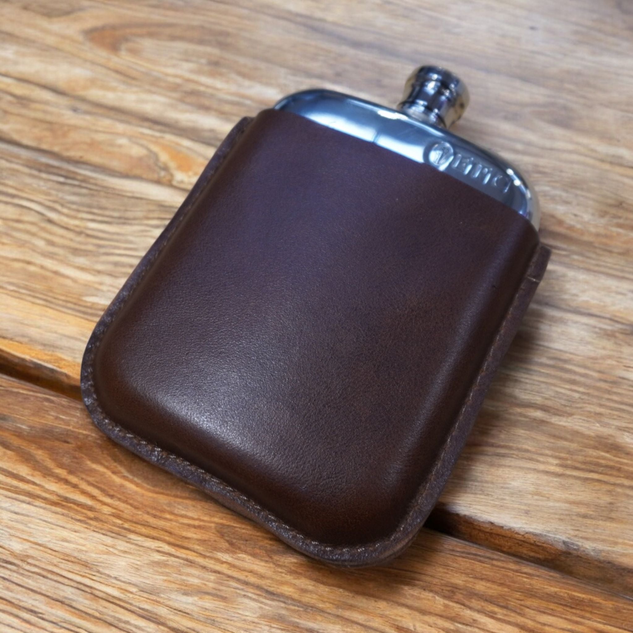 6oz Leather Sleeve Pewter Hip Flask available in four engravable colours: black, brown, tan, and oxblood