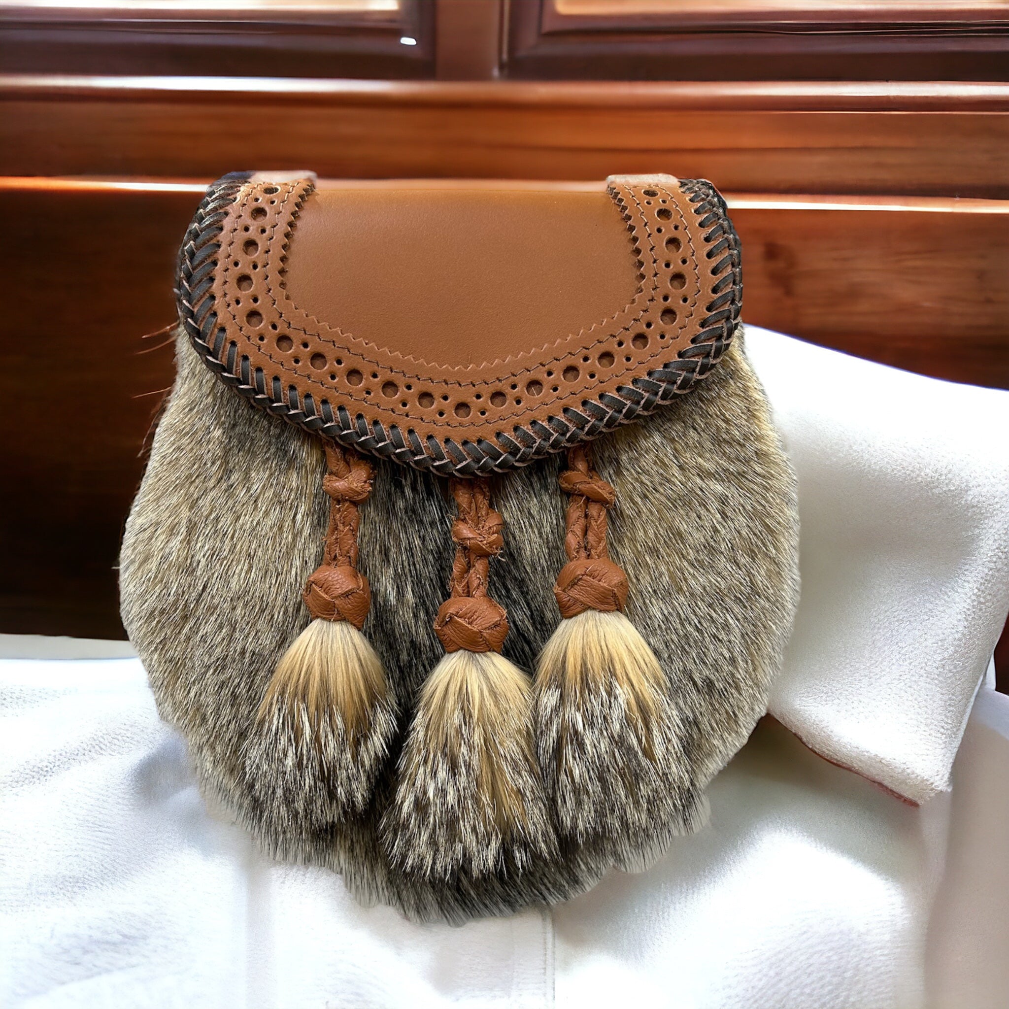 Artisan Classic sporran with braided leather lid, fur body and three fur and leather tassels