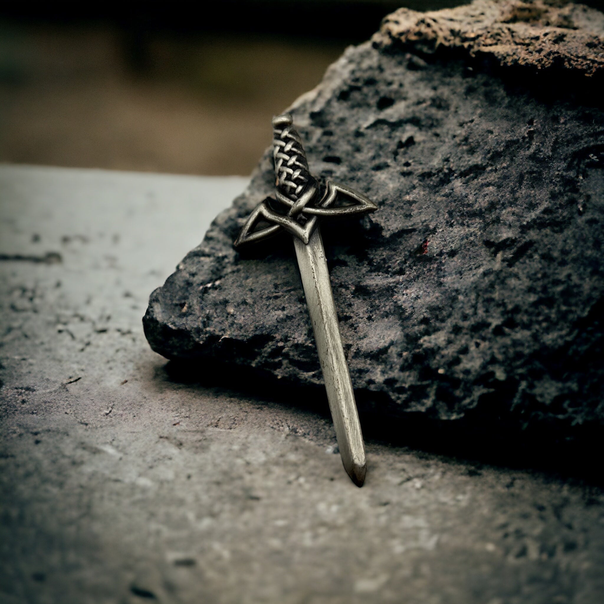 Traditional kilt pin with claymore sword design.