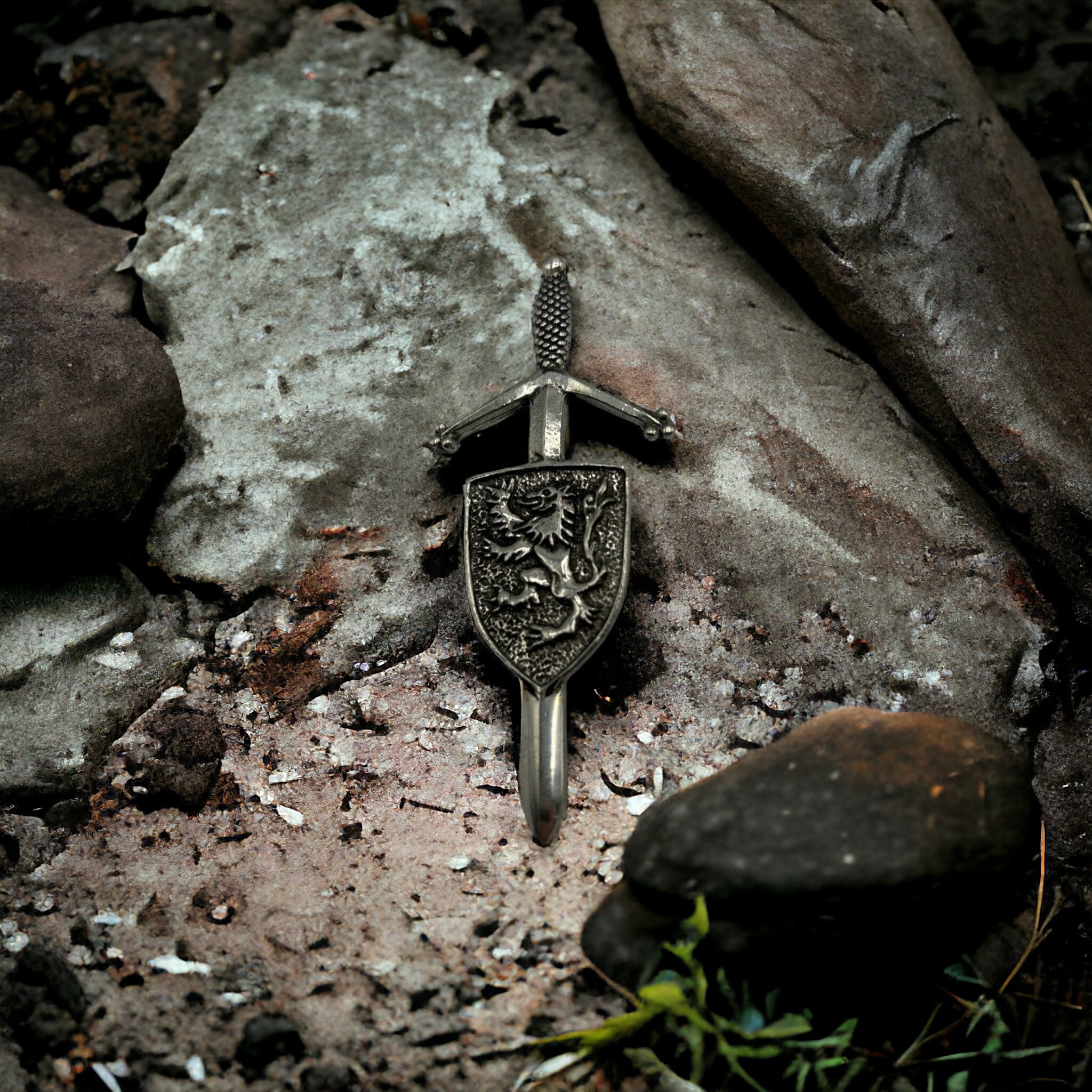Traditional pewter kilt pin with lion rampant and shield design.