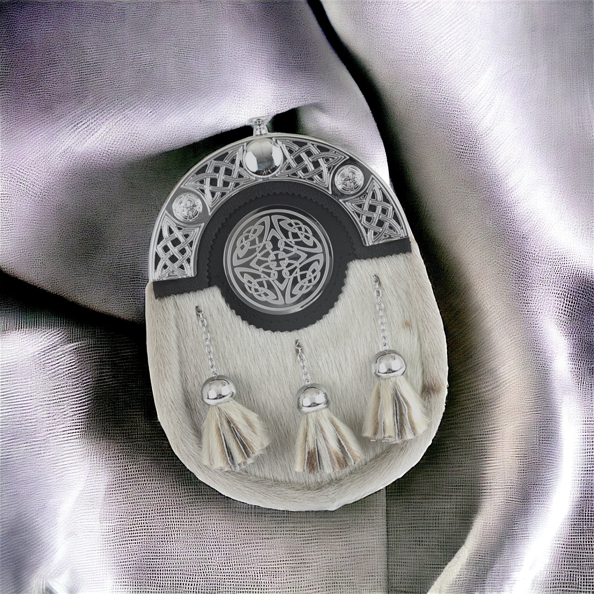 Dress sporran in seal skin with celtic engraved badge in center.